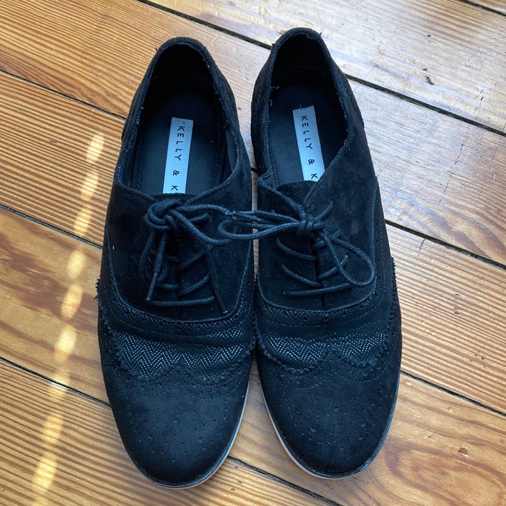 Black suede and lace detailed Oxford shoes with white soles.